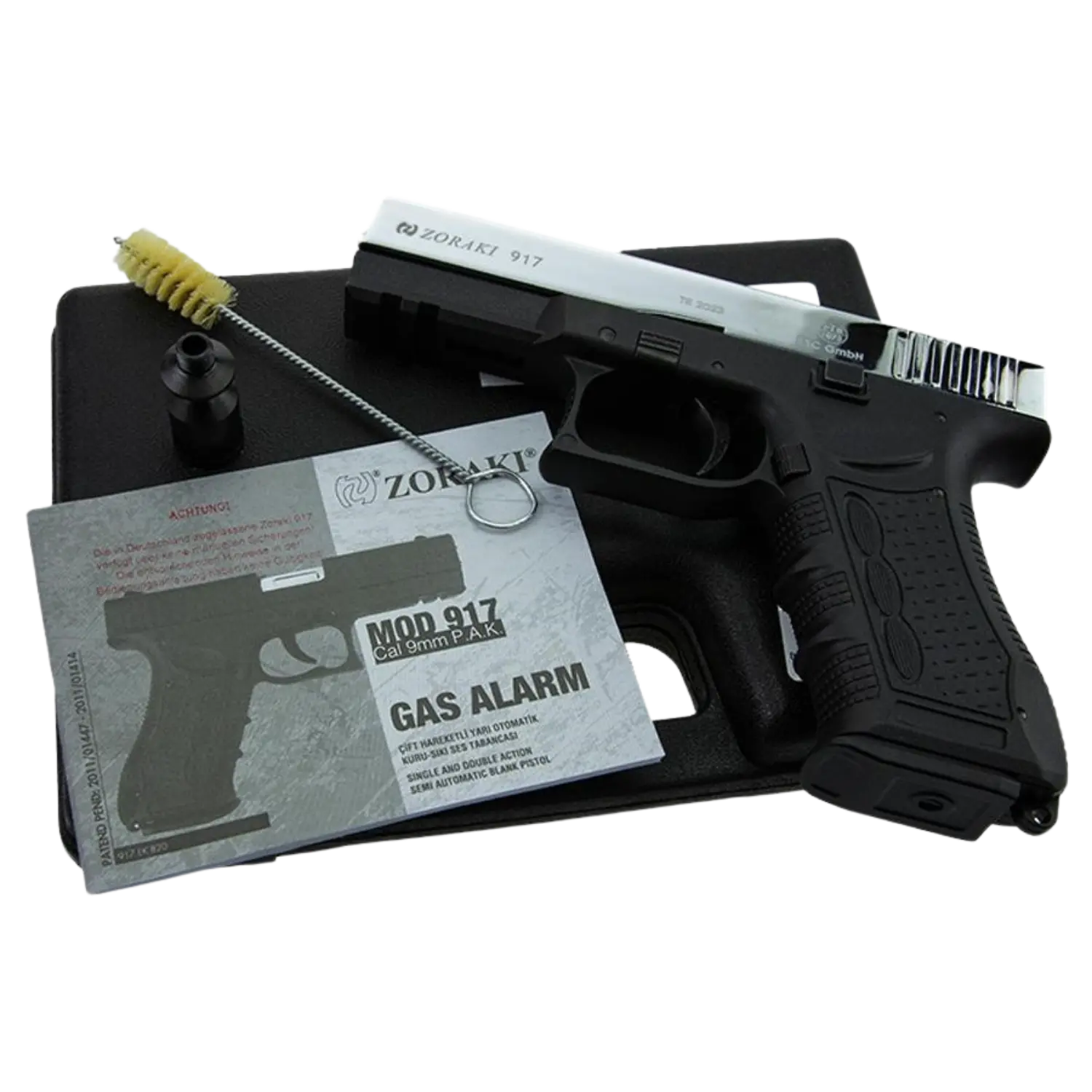 Schreckschusswaffe Zoraki 917 mit schwarzem Griff und silbernem Schlitten, Reinigungsbürste, Mündungsschutz und Bedienungsanleitung 'GAS ALARM'.