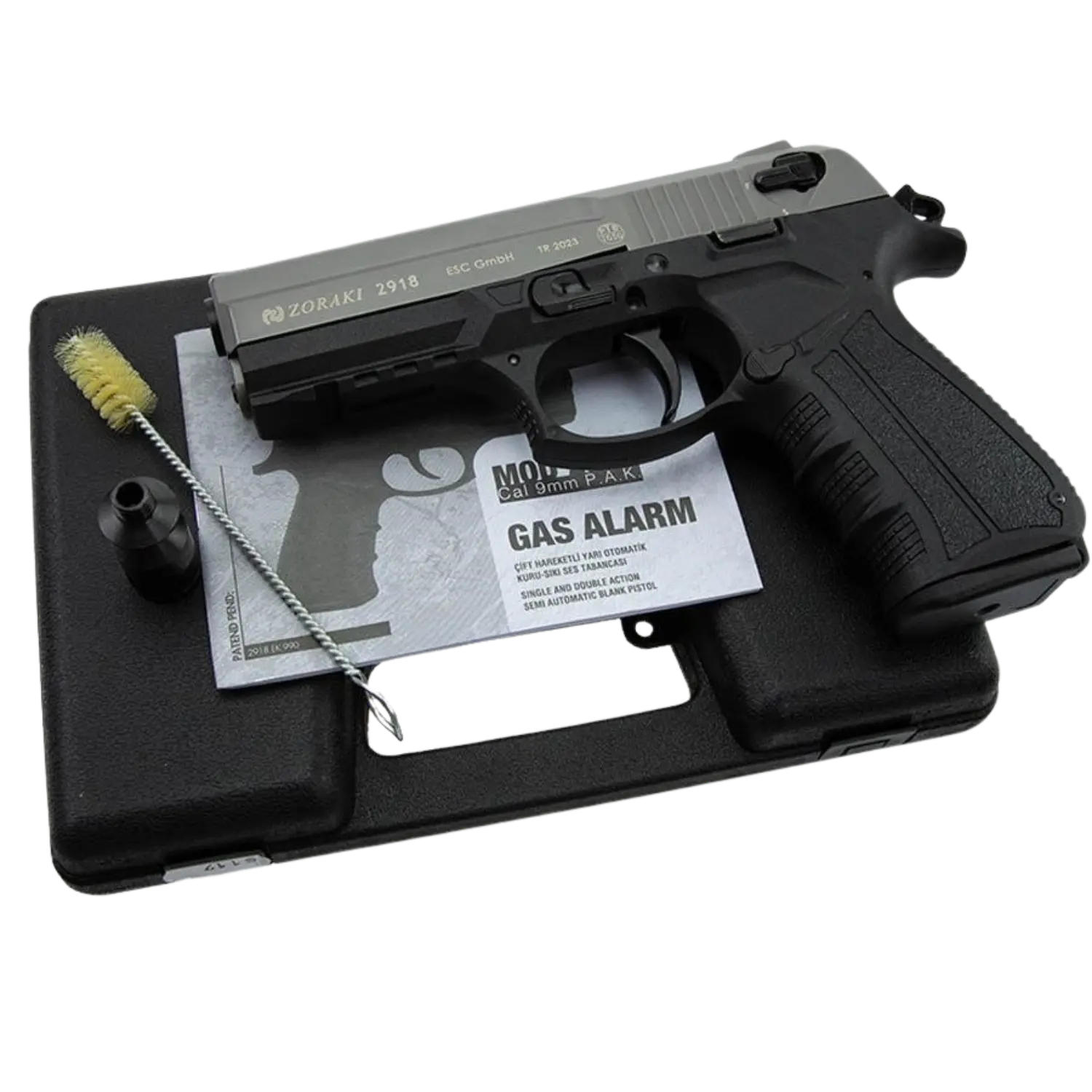 Zoraki 2918 Gasalarm-Pistole auf schwarzem Koffer, daneben eine Reinigungsbürste und ein Handbuch. Die Pistole hat einen schwarzen Griff und einen silbernen Schlitten.
